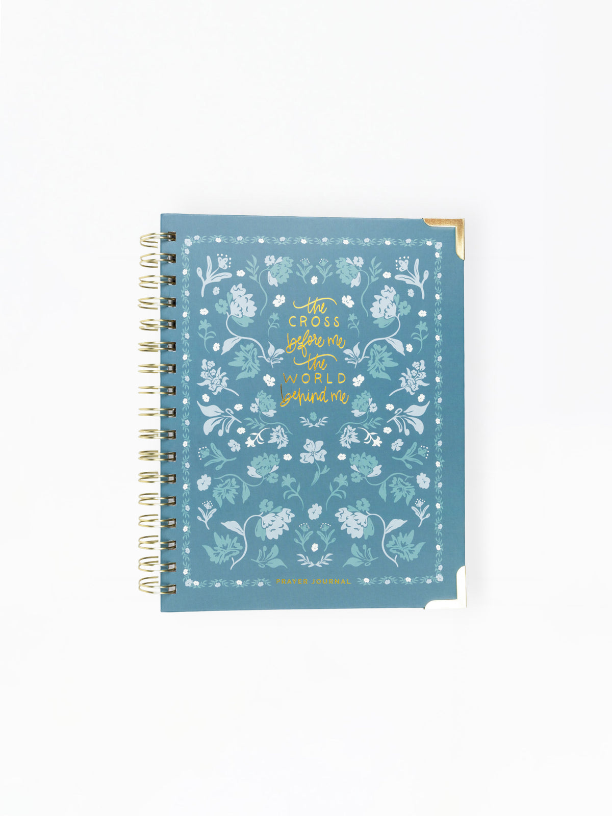 A spiral-bound notebook with a dusty blue cover decorated with white floral patterns and gold foil text reading 'with courage before me and hope behind me'.