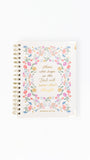 A spiral-bound lemon note journal featuring a colorful floral border and gold foil text on the cover, set against a plain white background.