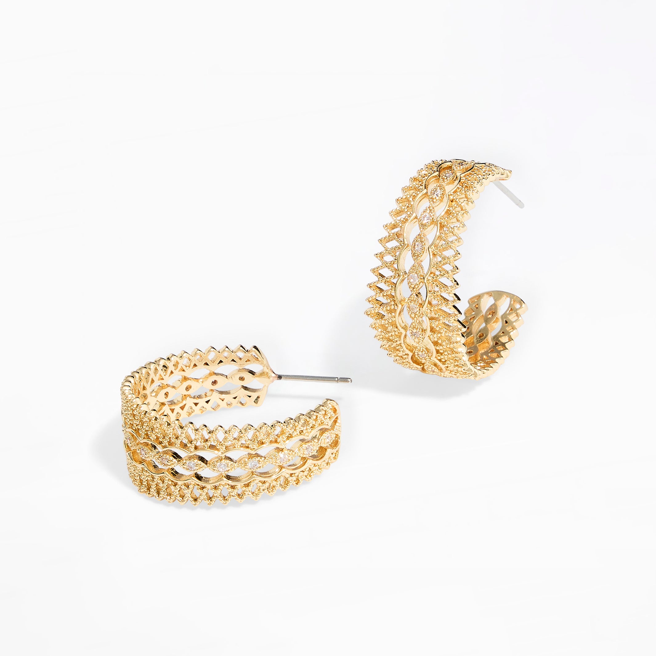 A pair of gold-toned, openwork hoop earrings with a textured, woven-like pattern, displayed on a clean white background.
