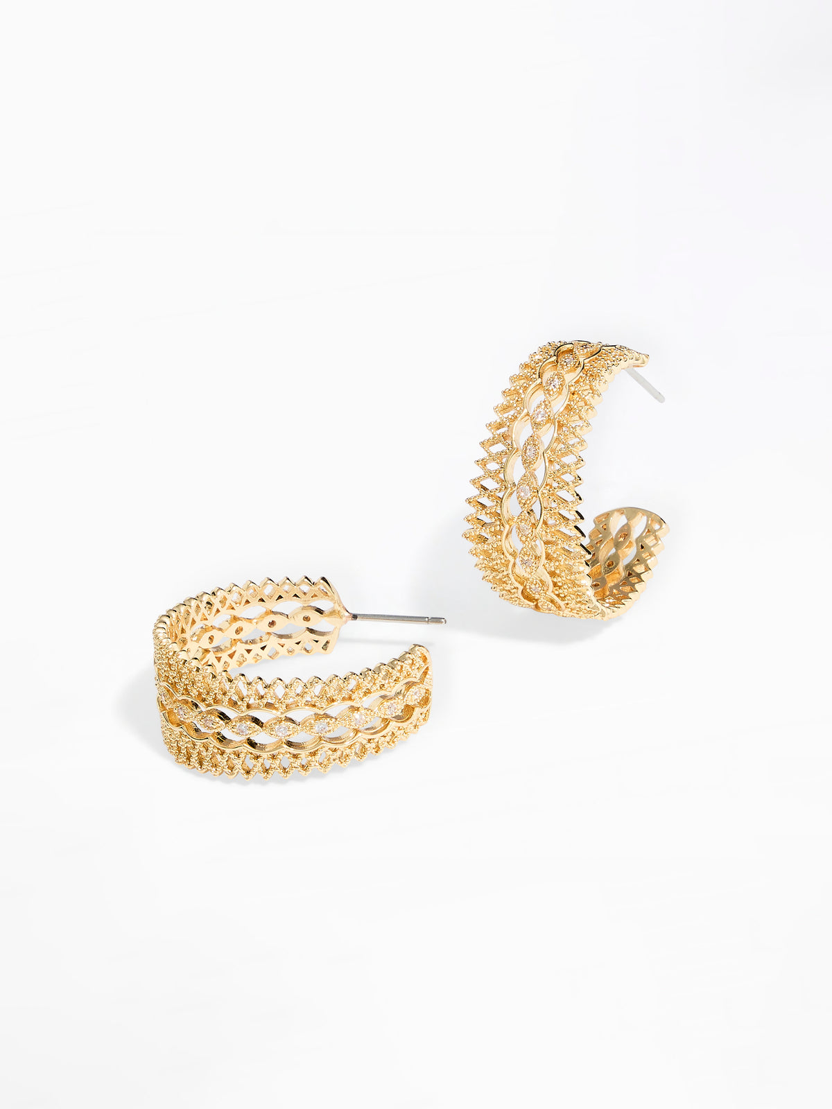 A pair of gold-toned, openwork hoop earrings with a textured, woven-like pattern, displayed on a clean white background.