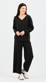Woman wearing a black outfit on a white background