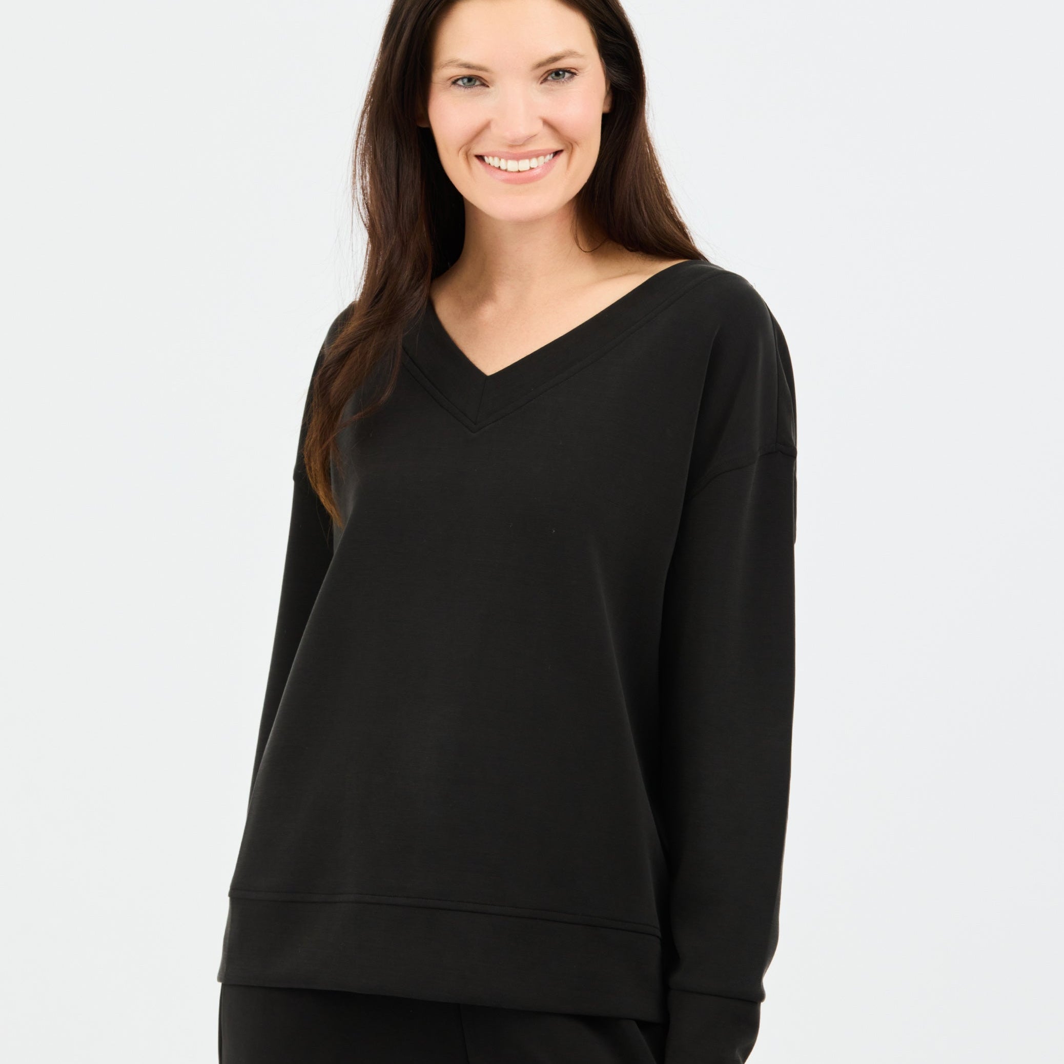 Woman wearing a black sweatshirt on a white background
