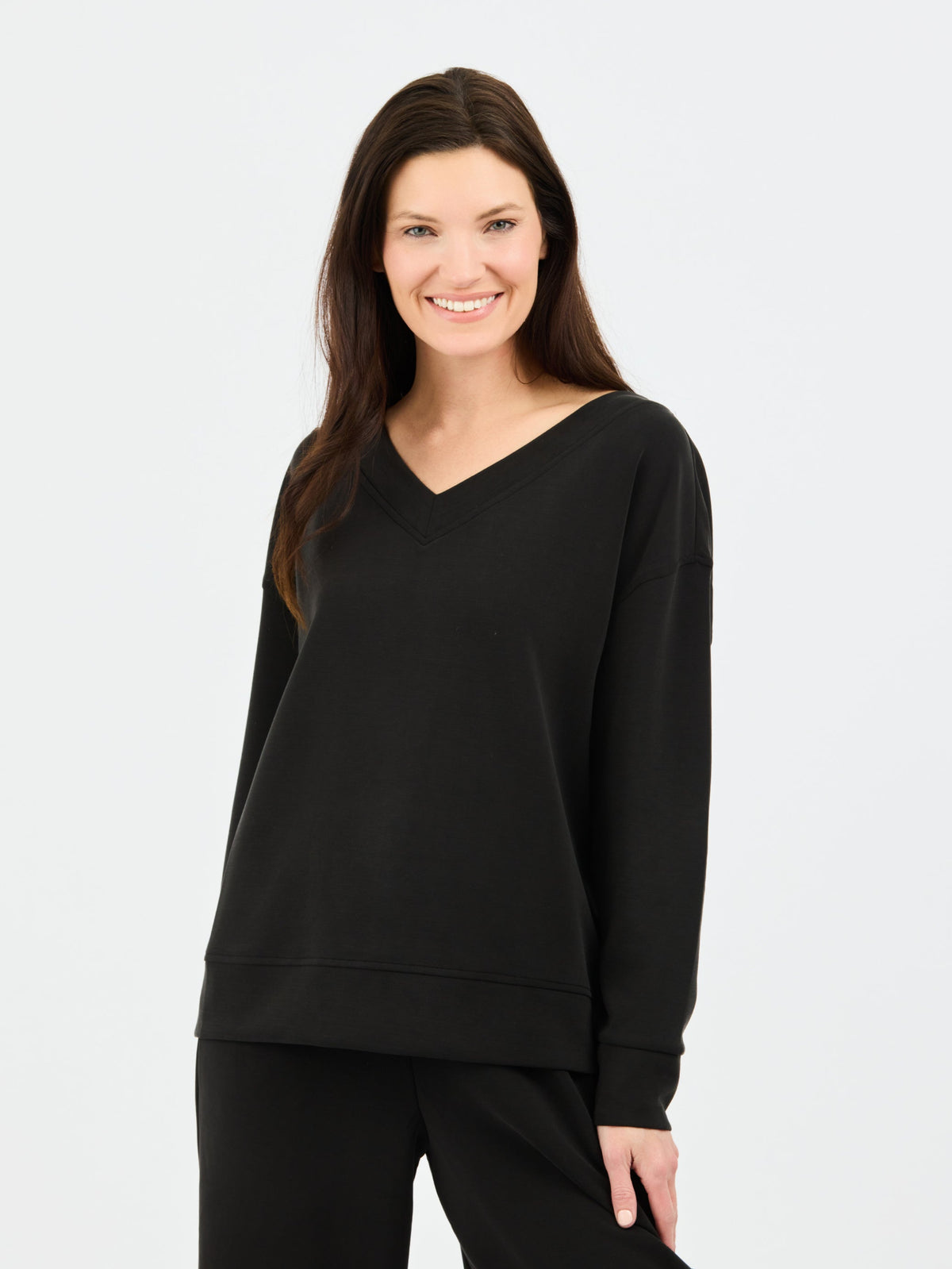 Woman wearing a black sweatshirt on a white background