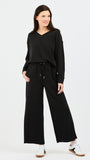 Woman wearing a black outfit on a white background