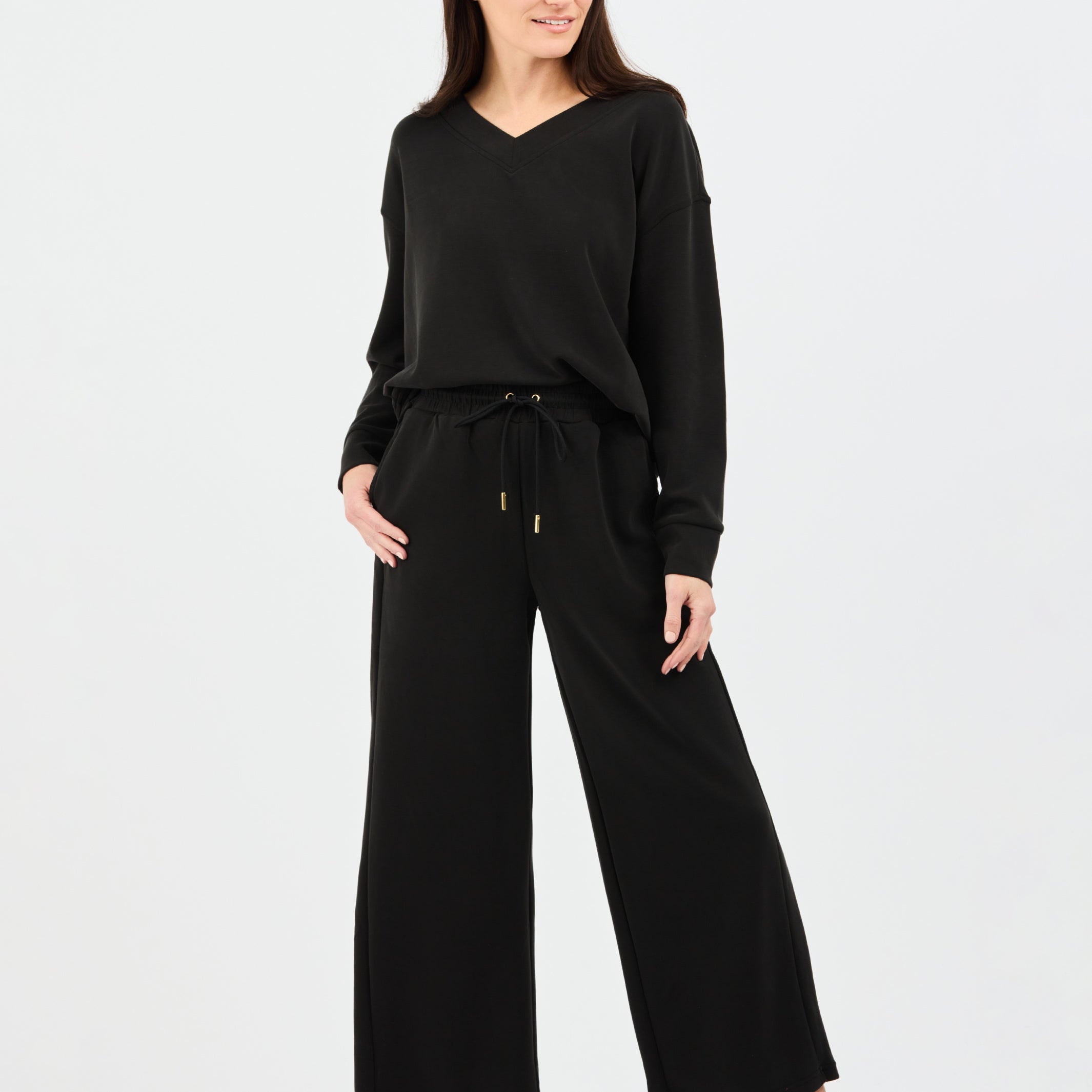 Woman wearing a black outfit on a white background