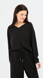 Woman wearing a black outfit on a white background