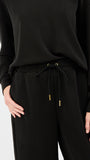 Black outfit with drawstring waist on a white background