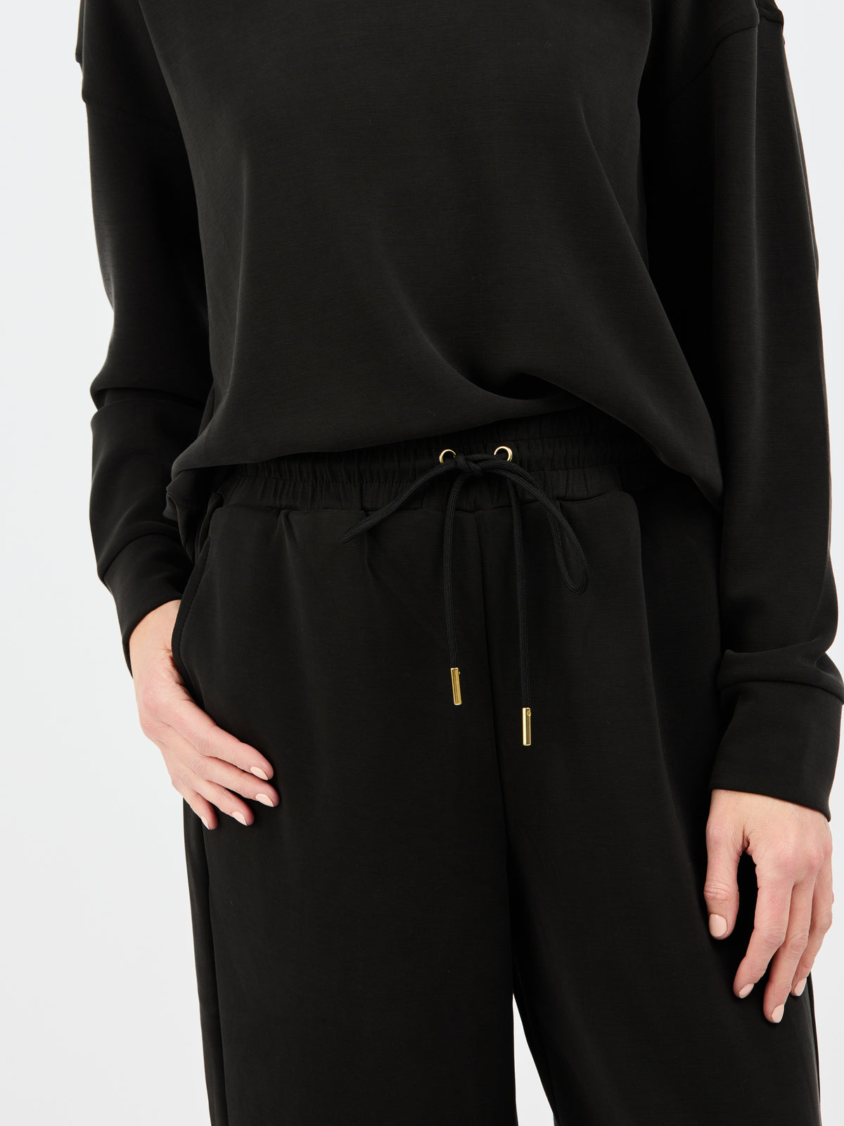 Black outfit with drawstring waist on a white background