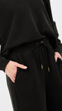 Black outfit with drawstring pants on a white background