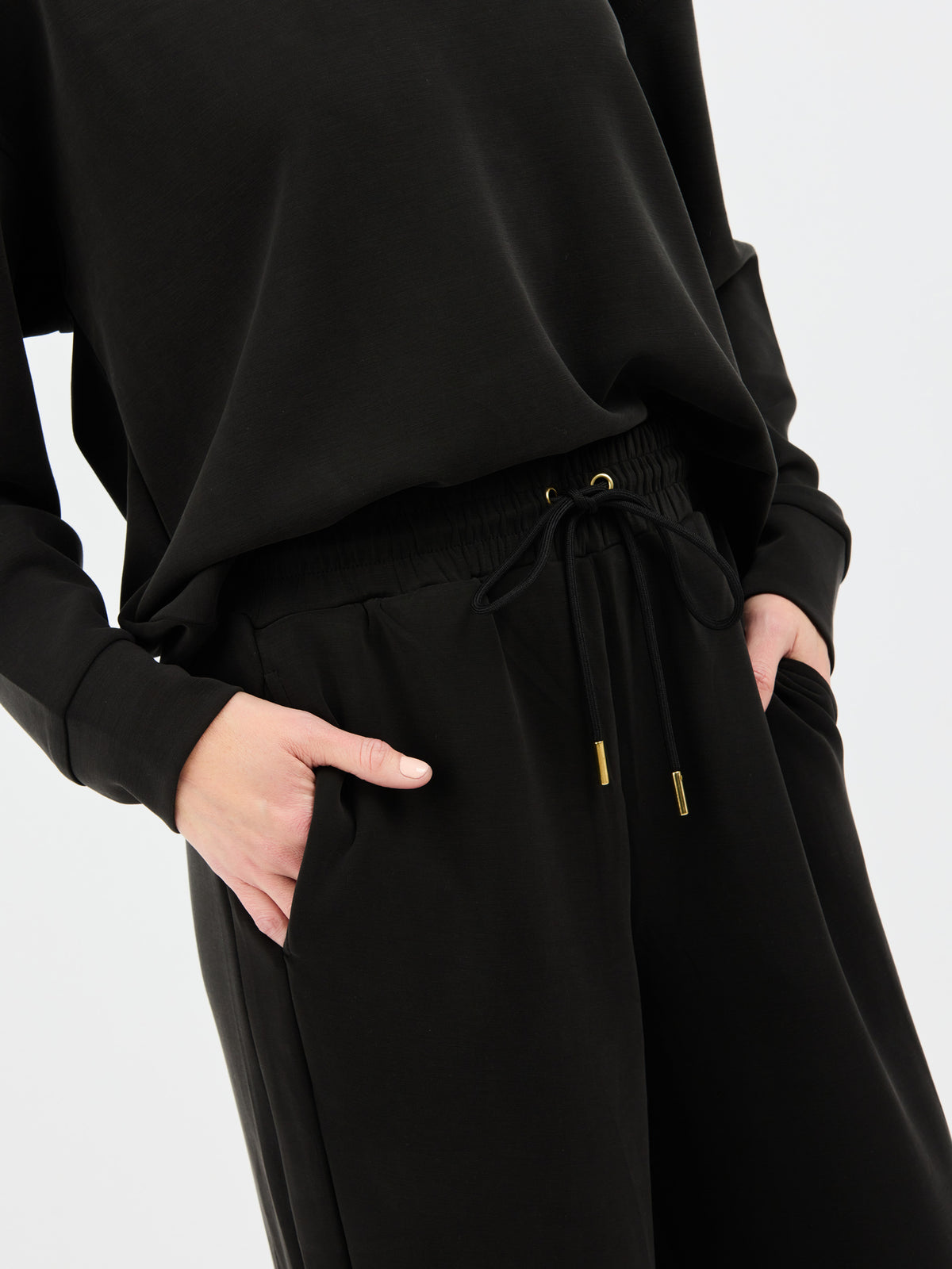 Black outfit with drawstring pants on a white background