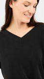 Woman wearing a black top against a white background