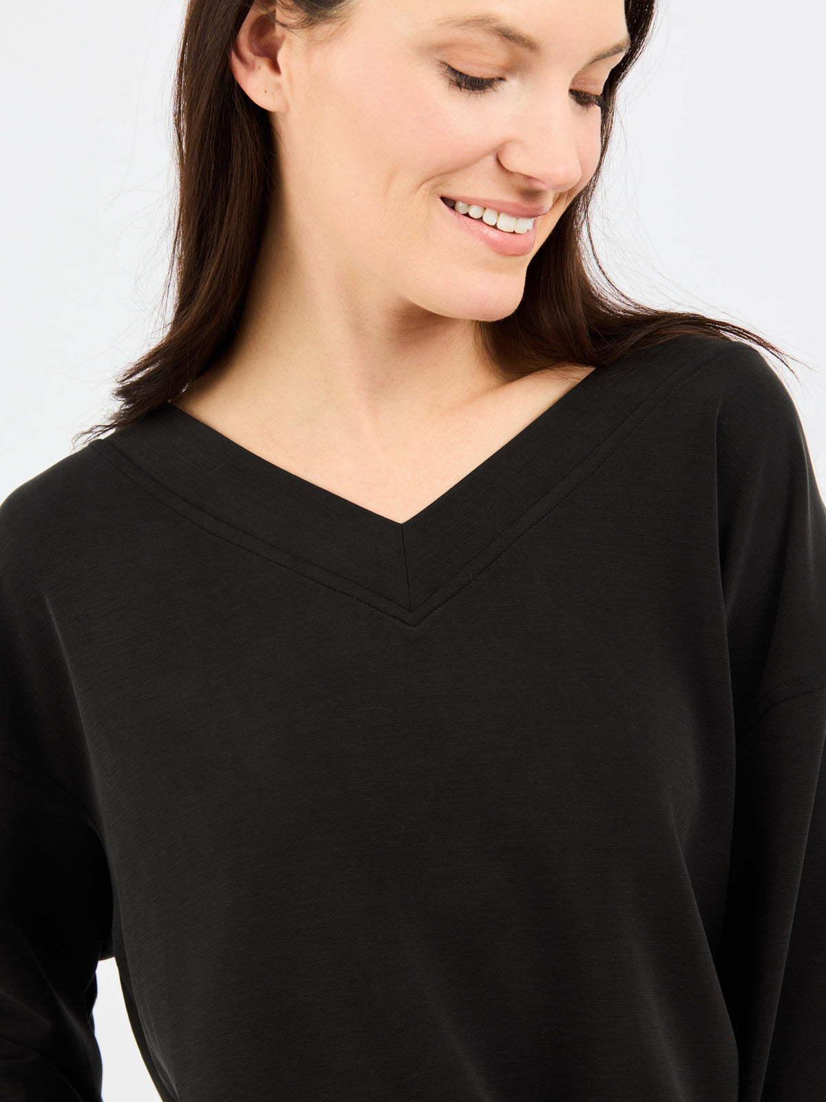 Woman wearing a black top against a white background