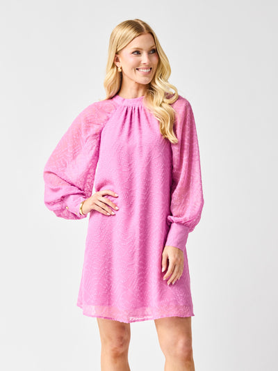 Woman wearing a pink dress with long sleeves on a white background