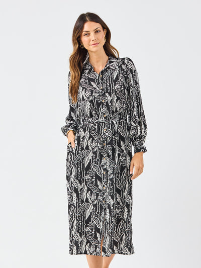 Woman wearing a black and white patterned dress on a white background