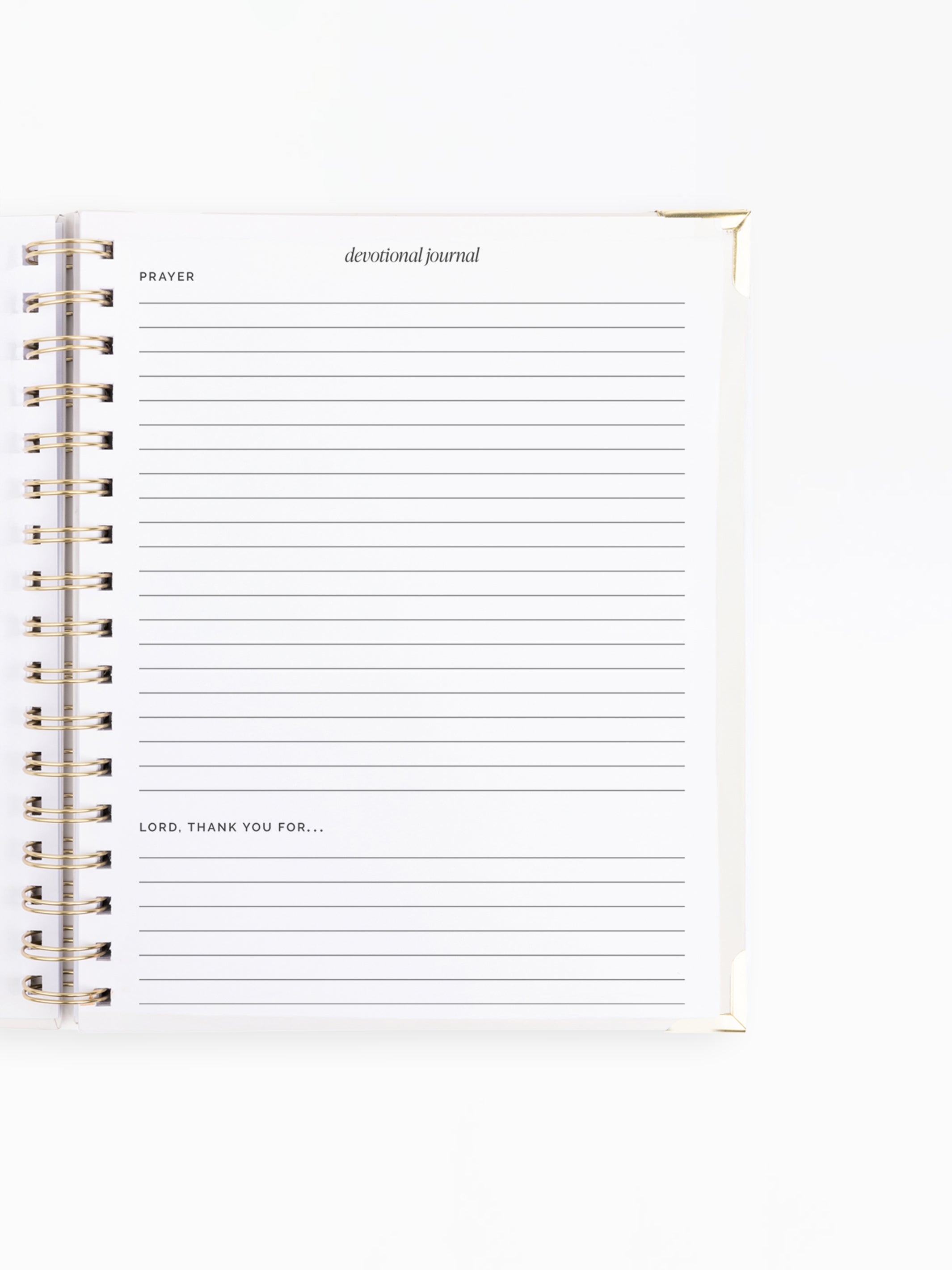 A white spiral-bound devotional journal with lined pages, gold-toned wire binding, and printed text including 'PRAYER' and 'devotional journal' on a clean white background.